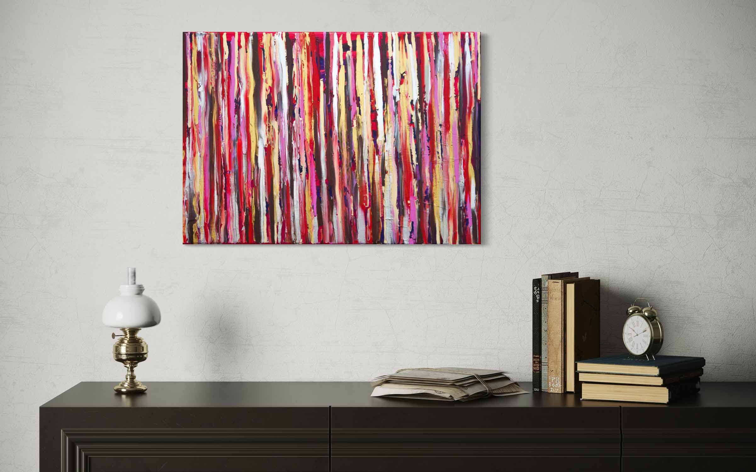 Abstract painting with vertical ribbons of red, pink, gold, and brown, textured acrylic on canvas, hanging on wall over a cabinet