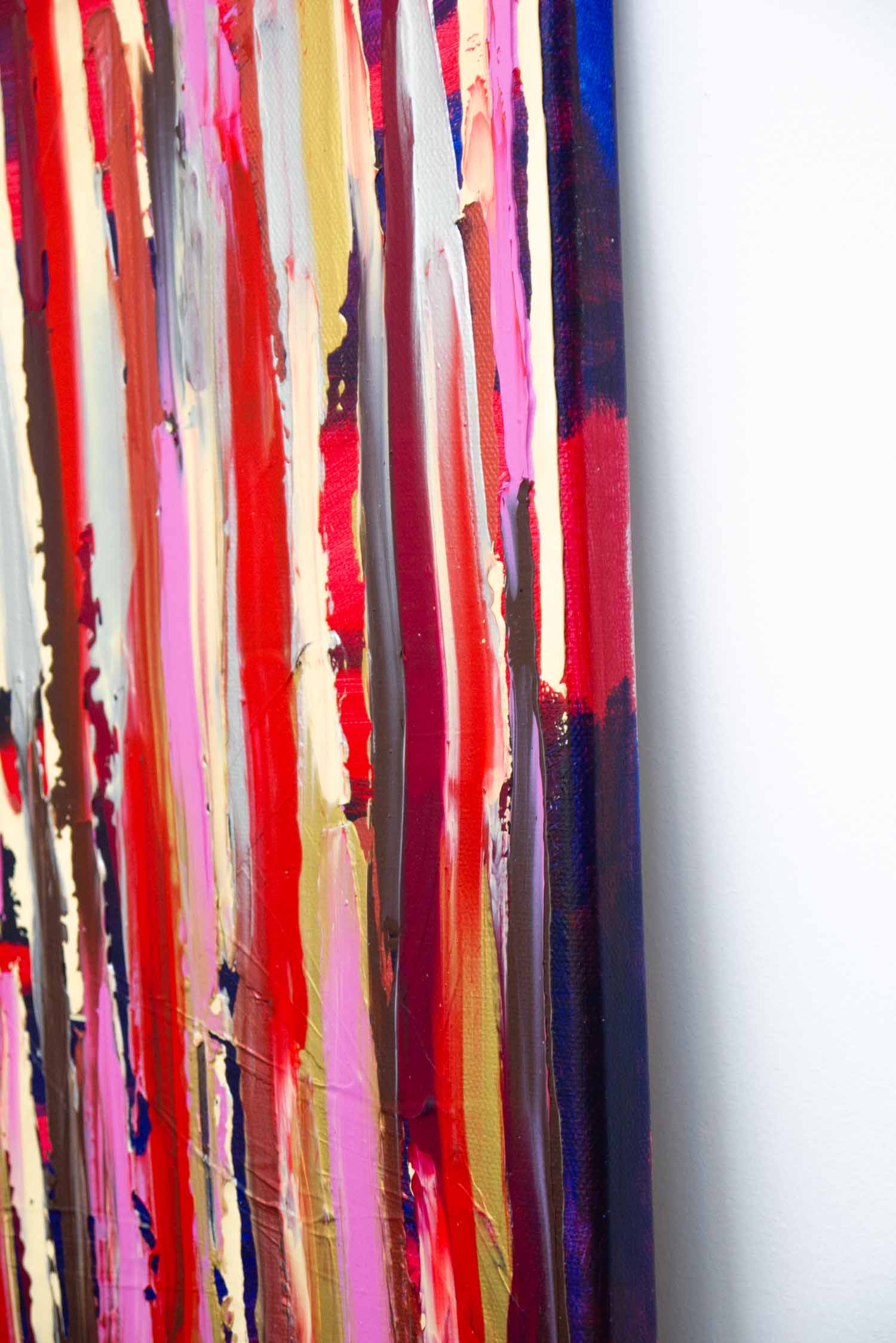 close up of an abstract painting with vertical ribbons of red, pink, gold, and brown, textured acrylic on canvas